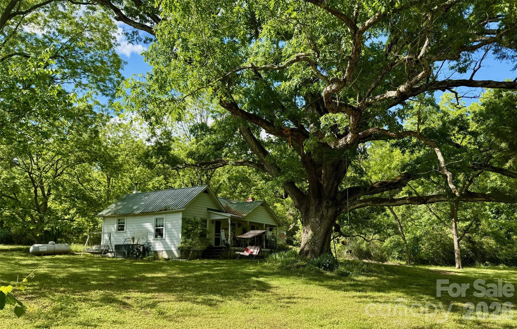 36299 Finger Road Mount Pleasant, NC 28124 - Photo 6 of 8 a view of a house with a big yard and large trees