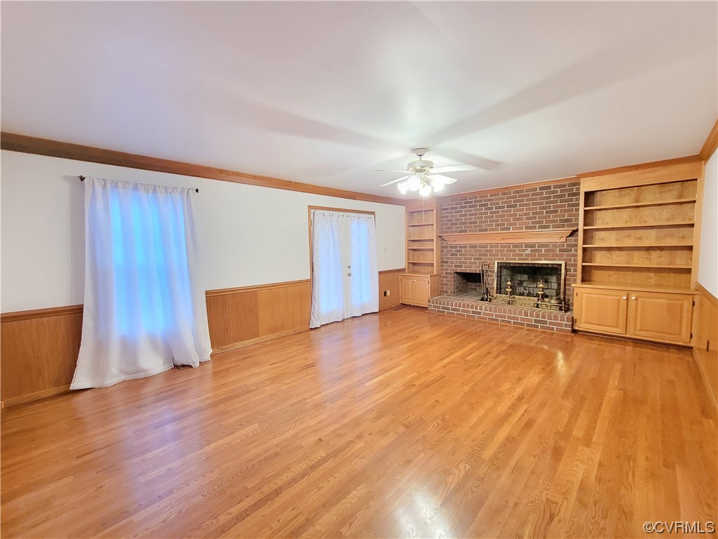 13004 Rockridge Road Chester, VA 23831 - Photo 14 of 38 a view of empty room with wooden floor and fireplace