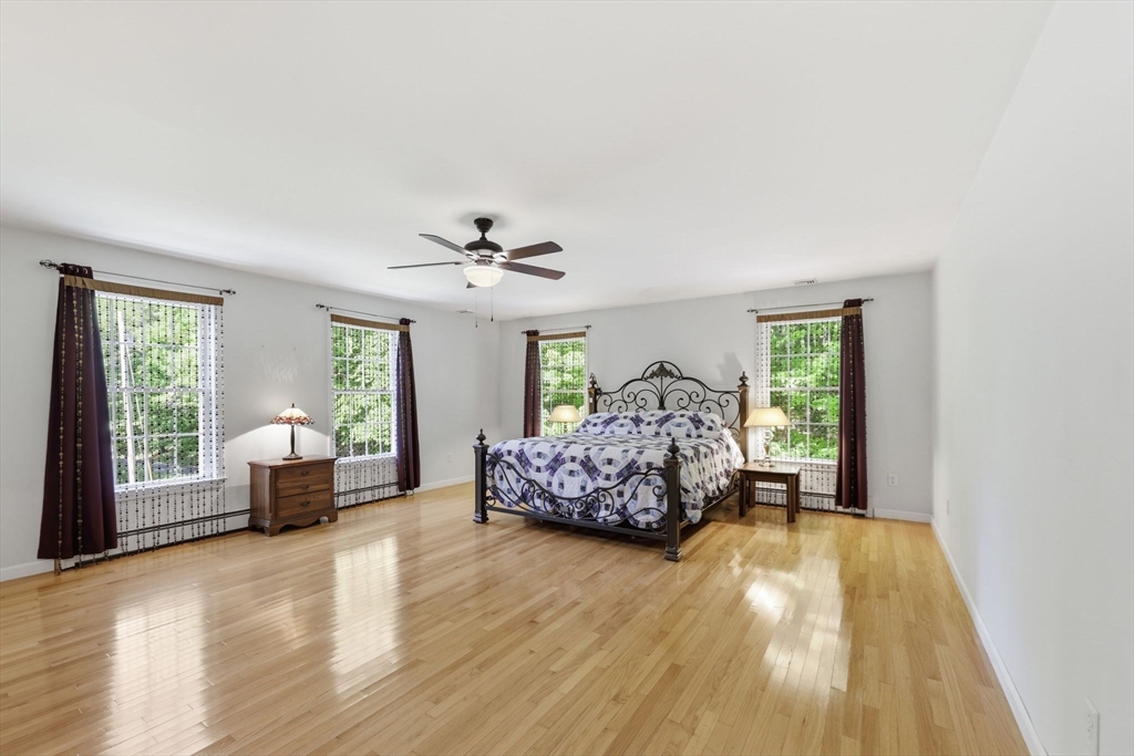 345 Bragg Road Warren, MA 01585 - Photo 22 of 41 a bedroom with a bed and wooden floor