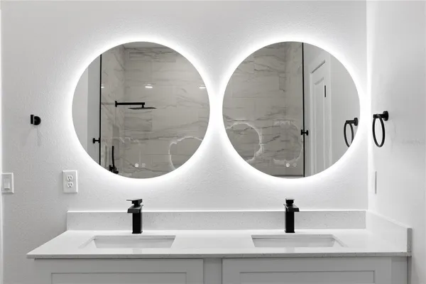 an view of living room with a mirror and vanity