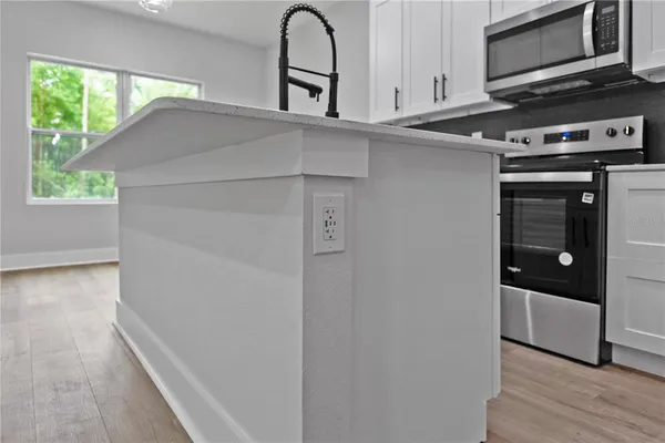 a kitchen with stainless steel appliances a refrigerator and a stove