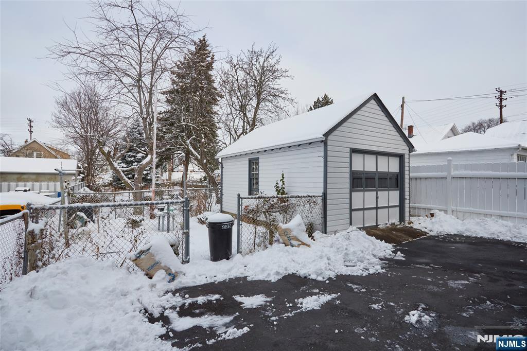 235 Dundee Avenue Paterson, NJ 07503 - Photo 3 of 12 a front view of a house with a yard