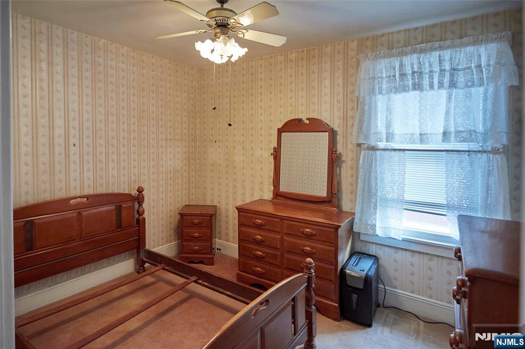 235 Dundee Avenue Paterson, NJ 07503 - Photo 8 of 12 a room with furniture and wooden floor
