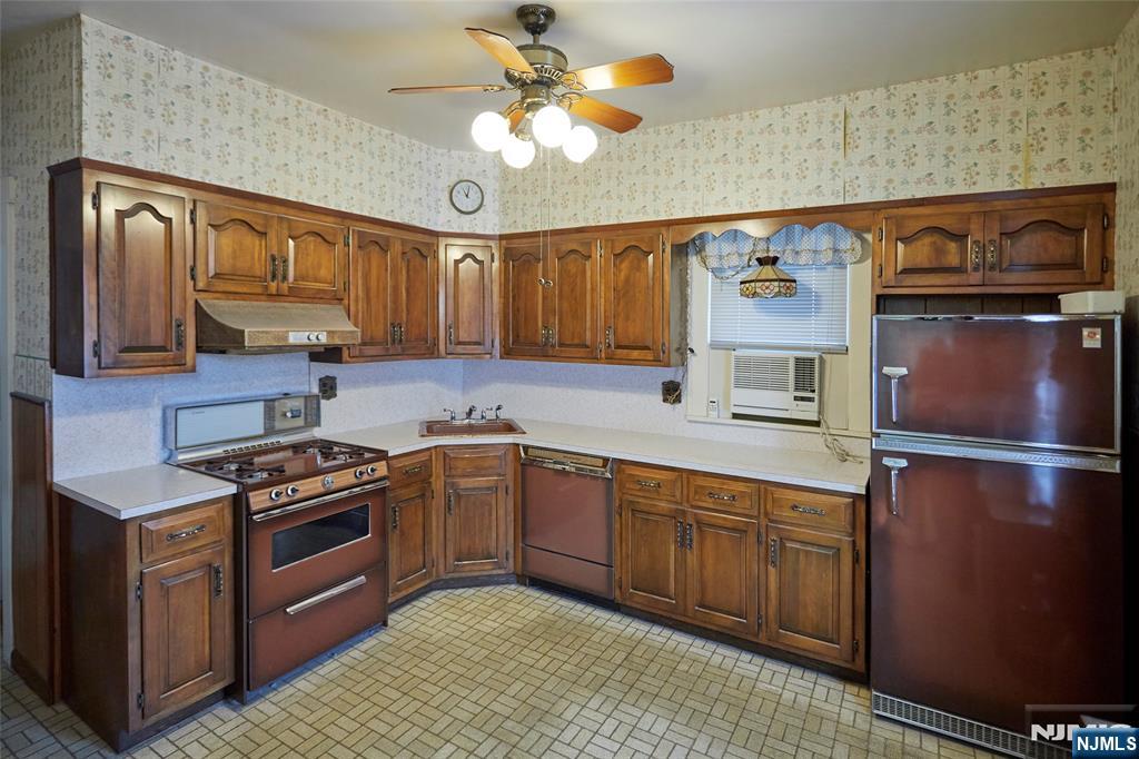 235 Dundee Avenue Paterson, NJ 07503 - Photo 10 of 12 a kitchen with stainless steel appliances granite countertop a stove and a sink