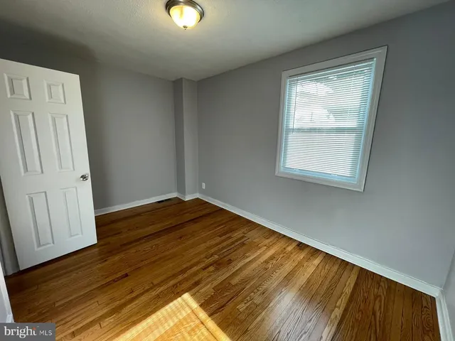 a view of a room with wooden floor and cabinet