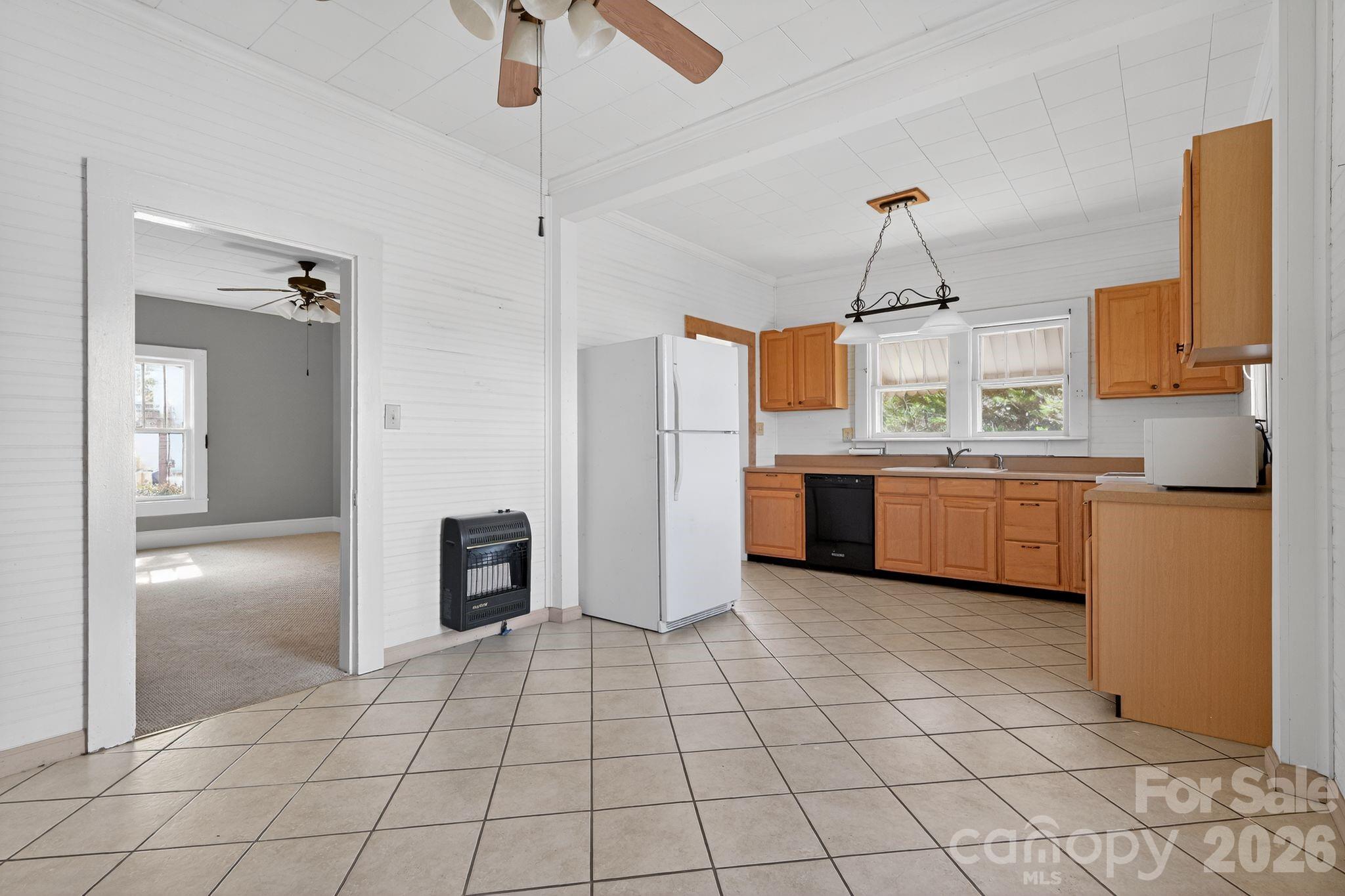 137 Duke Street Granite Falls, NC 28630 - Photo 4 of 16 a kitchen with stainless steel appliances a sink and a refrigerator