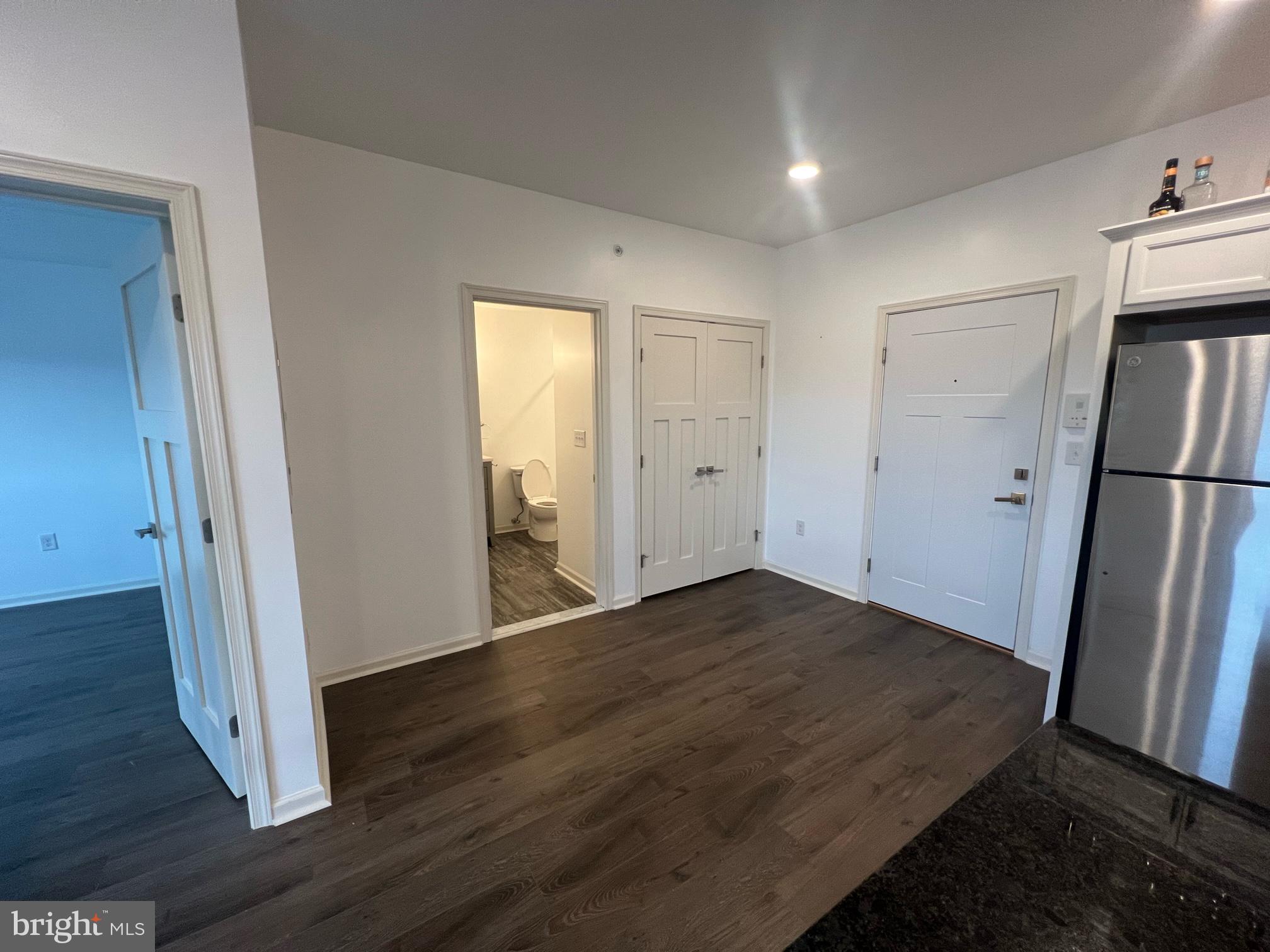 5312 Ridge Avenue, Unit 407 Philadelphia, PA 19128 - Photo 5 of 7 an empty room with wooden floor and entrance