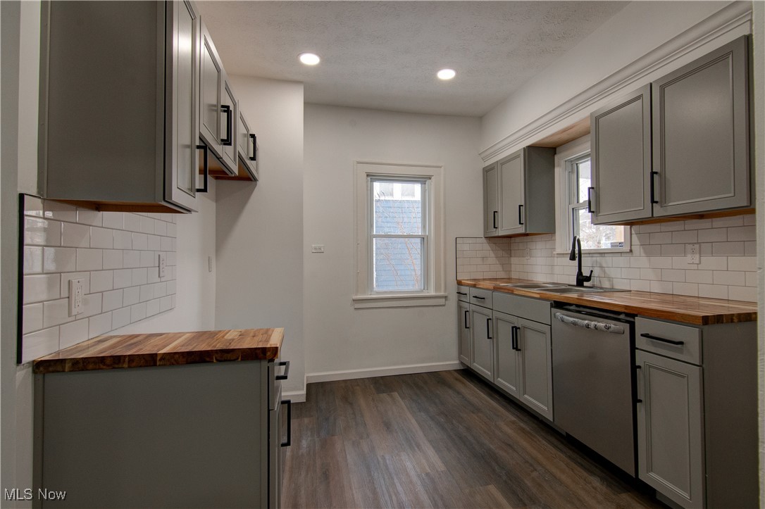 3357 Kildare Road Cleveland, OH 44118 - Photo 10 of 26 Kitchen featuring wood counters, dark wood-type flooring, stainless steel dishwasher, and gray cabinetry