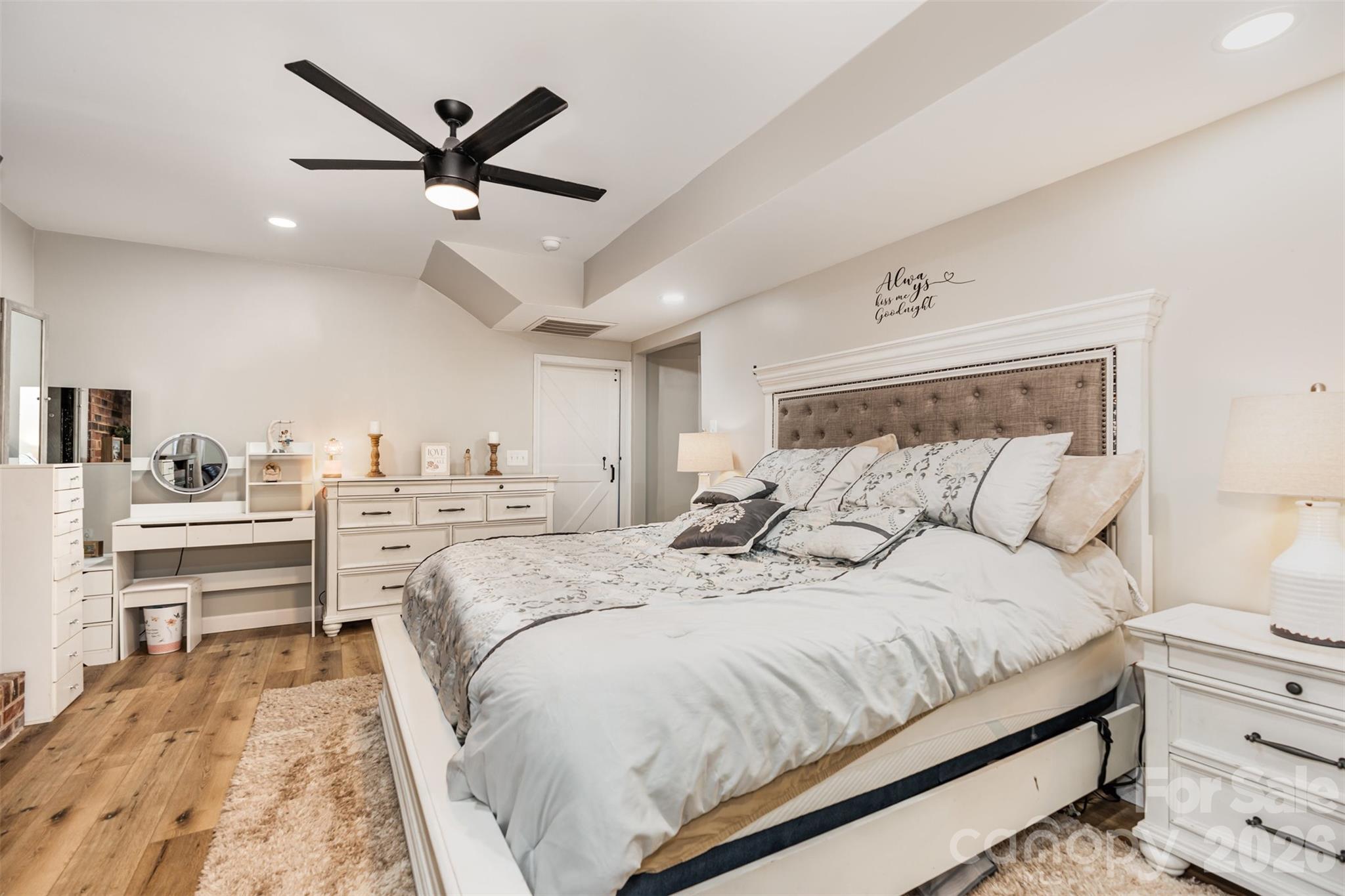 197 Sain Road Statesville, NC 28625 - Photo 31 of 44 a bedroom with a large bed and a chandelier