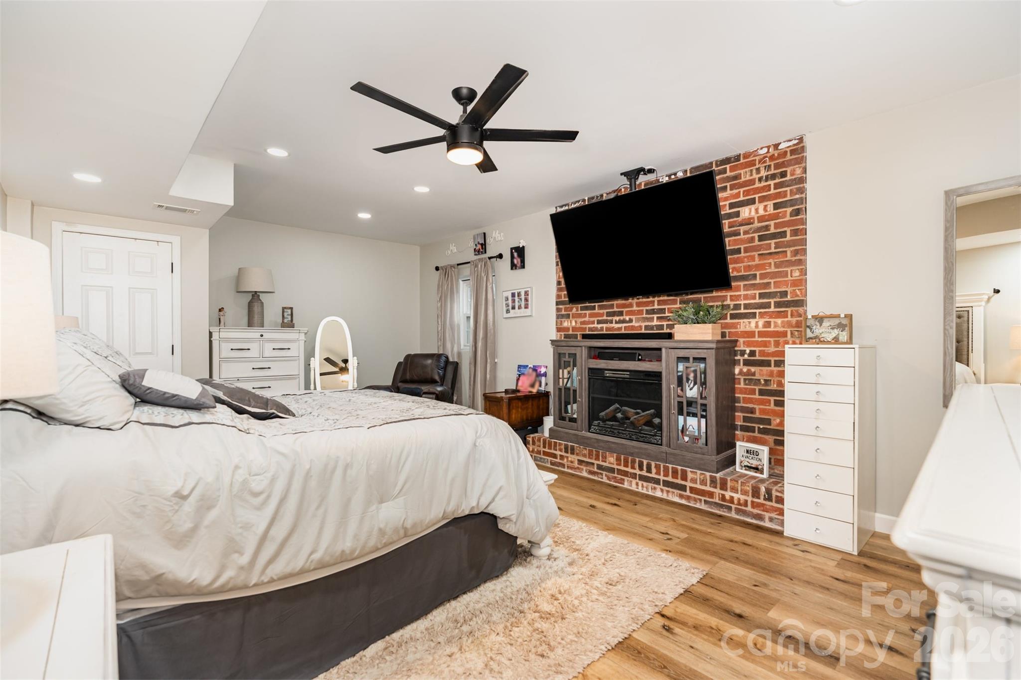 197 Sain Road Statesville, NC 28625 - Photo 32 of 44 a spacious bedroom with a bed and a flat screen tv