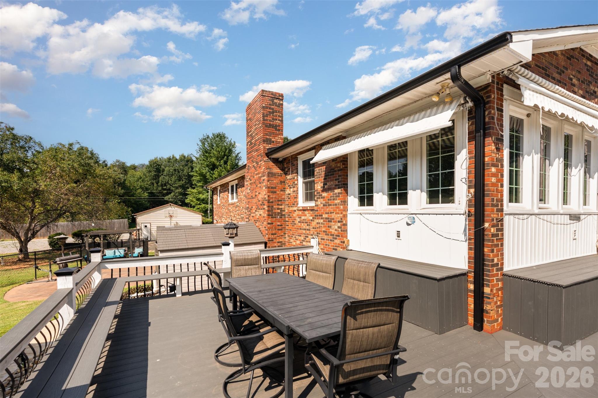 197 Sain Road Statesville, NC 28625 - Photo 37 of 44 a view of a patio with table and chairs with wooden floor and fence