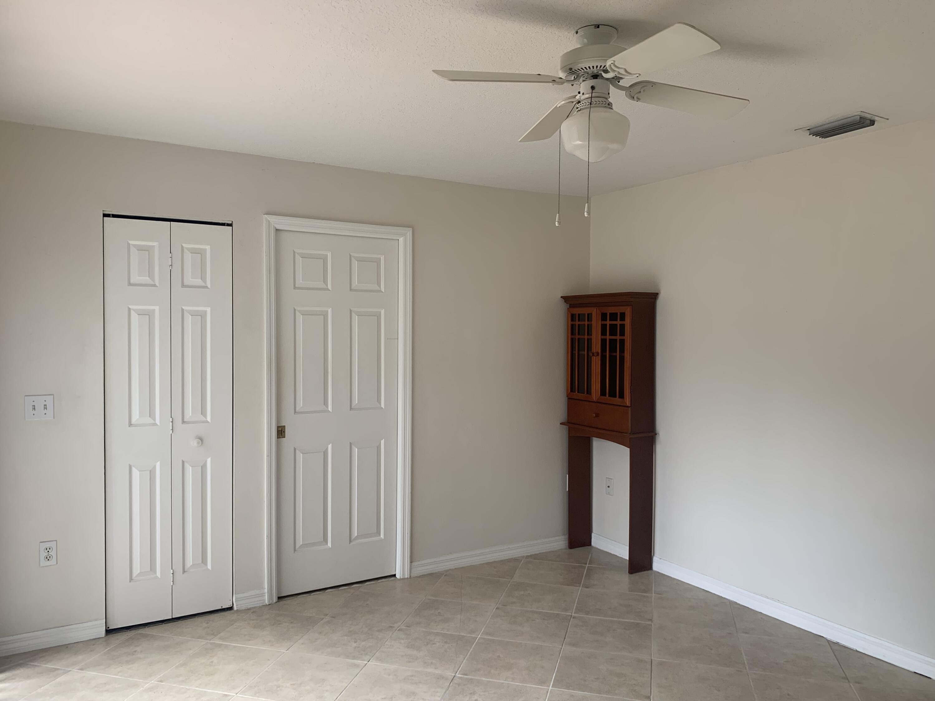 3409 12th Street Southwest Vero Beach, FL 32968 - Photo 19 of 26 an empty room with a chandelier fan