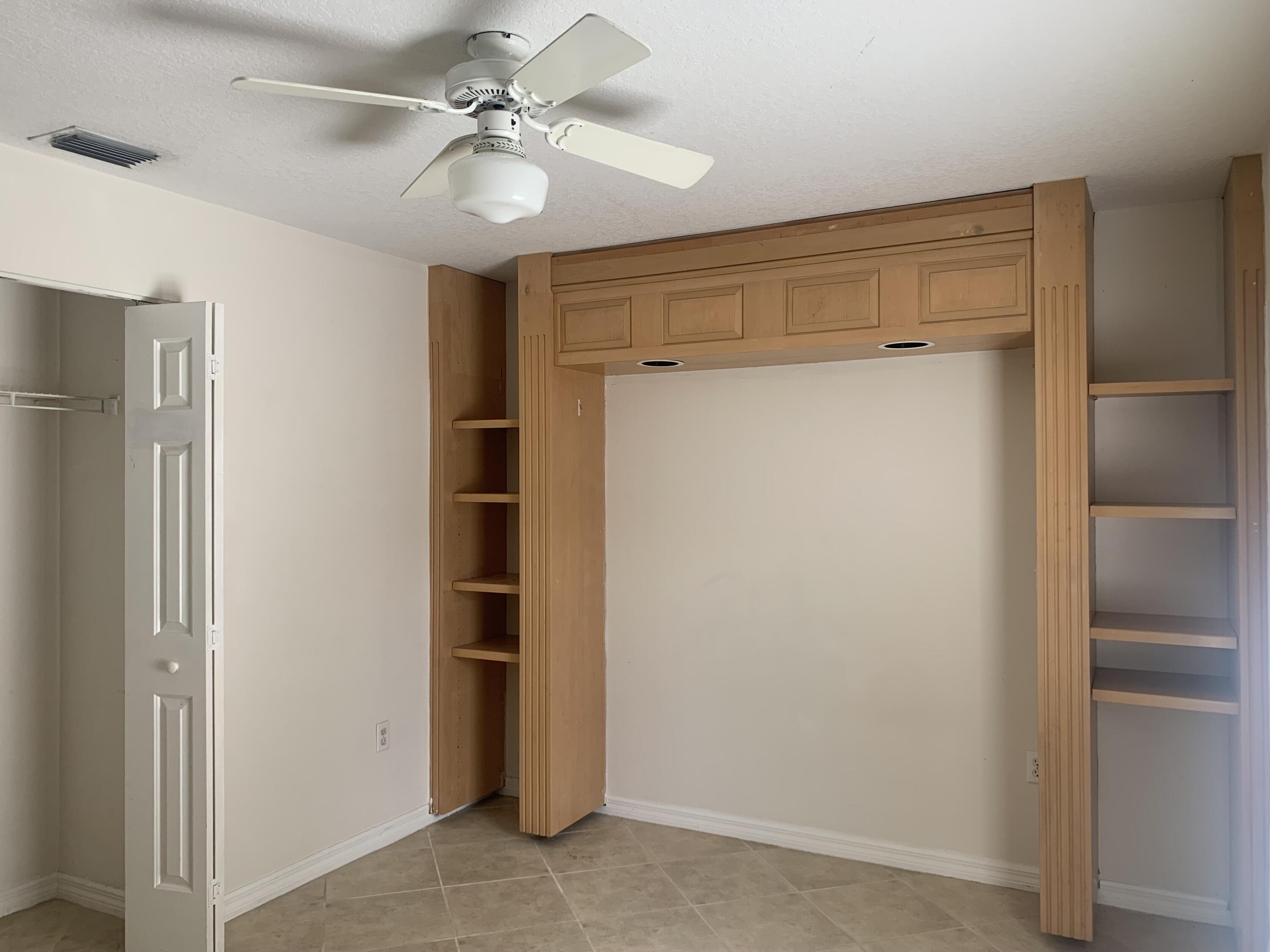 3409 12th Street Southwest Vero Beach, FL 32968 - Photo 21 of 26 a view of a hallway with closet and chandelier fan