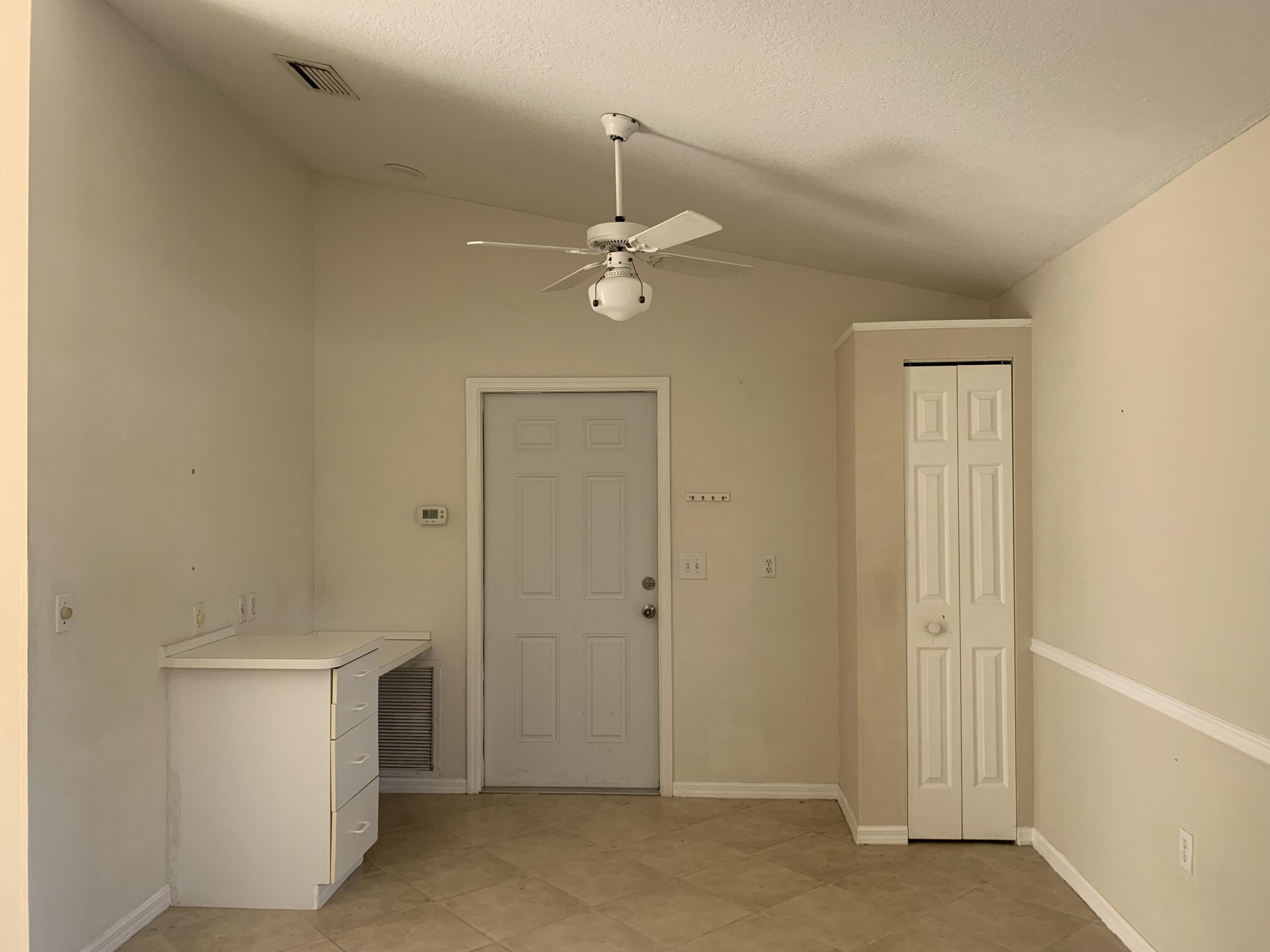 3409 12th Street Southwest Vero Beach, FL 32968 - Photo 24 of 26 an empty room with a ceiling fan and a window