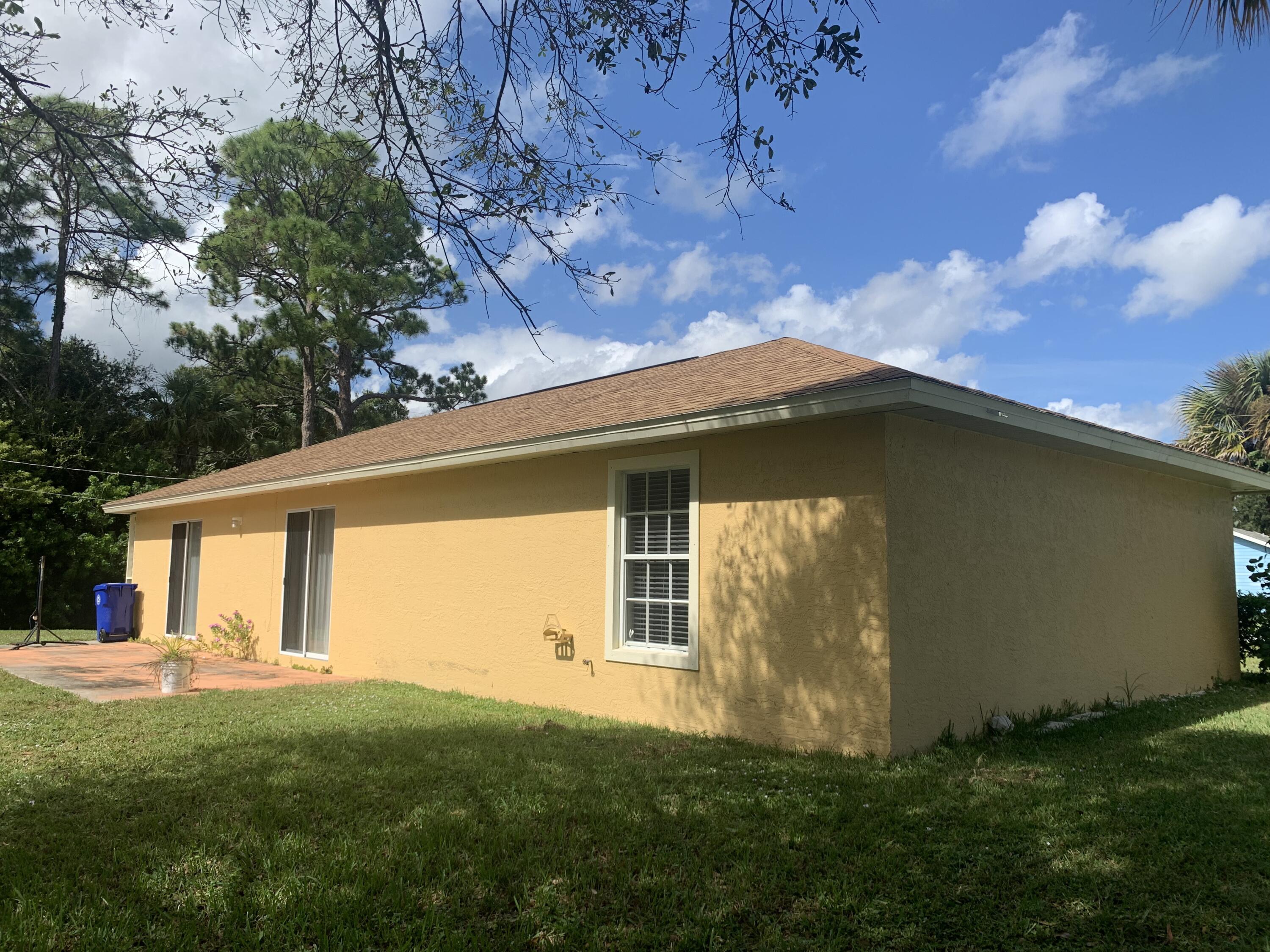 3409 12th Street Southwest Vero Beach, FL 32968 - Photo 7 of 26 a front view of a house with a yard