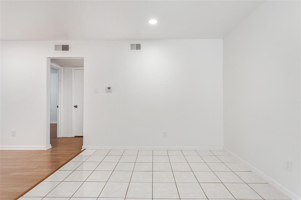 6061 Milton Street, Unit 231 Dallas, TX 75206 - Photo 4 of 27 Open-concept living room offering generous proportions and seamless flow toward the dining area and kitchen.