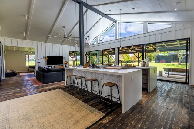 a kitchen with sink and view of living room