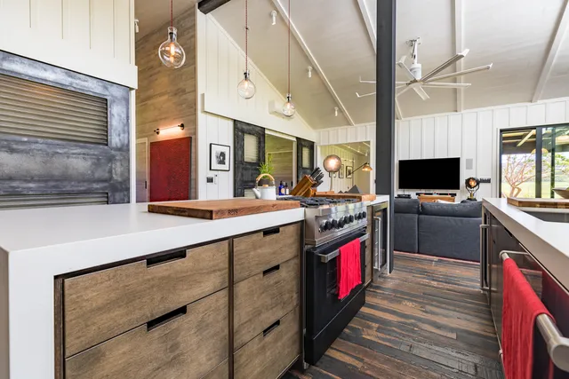 a bathroom with a sink a mirror and next to a window