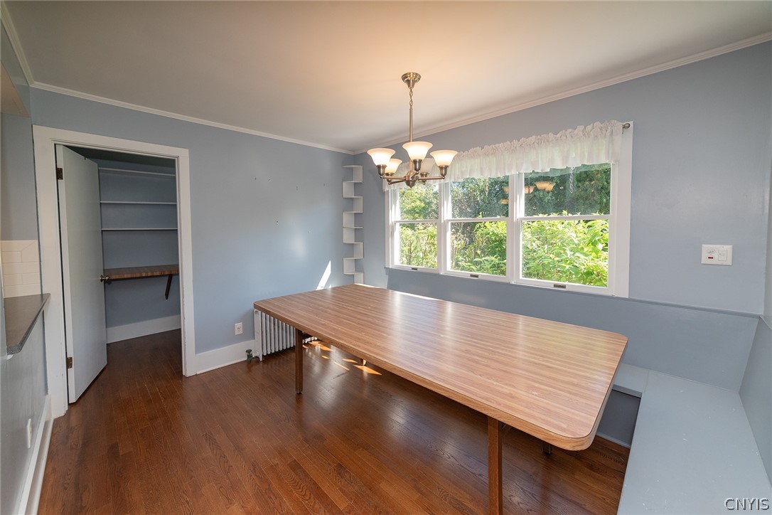 167 Beverly Road Syracuse, NY 13207 - Photo 22 of 50 Rich wood flooring anchors this dining space illuminated by a classic chandelier.