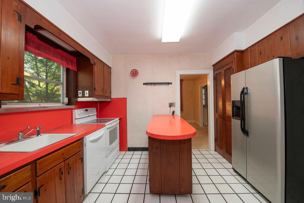 103 Waverly Road Wyncote, PA 19095 - Photo 14 of 41 a kitchen with a sink cabinets and a refrigerator