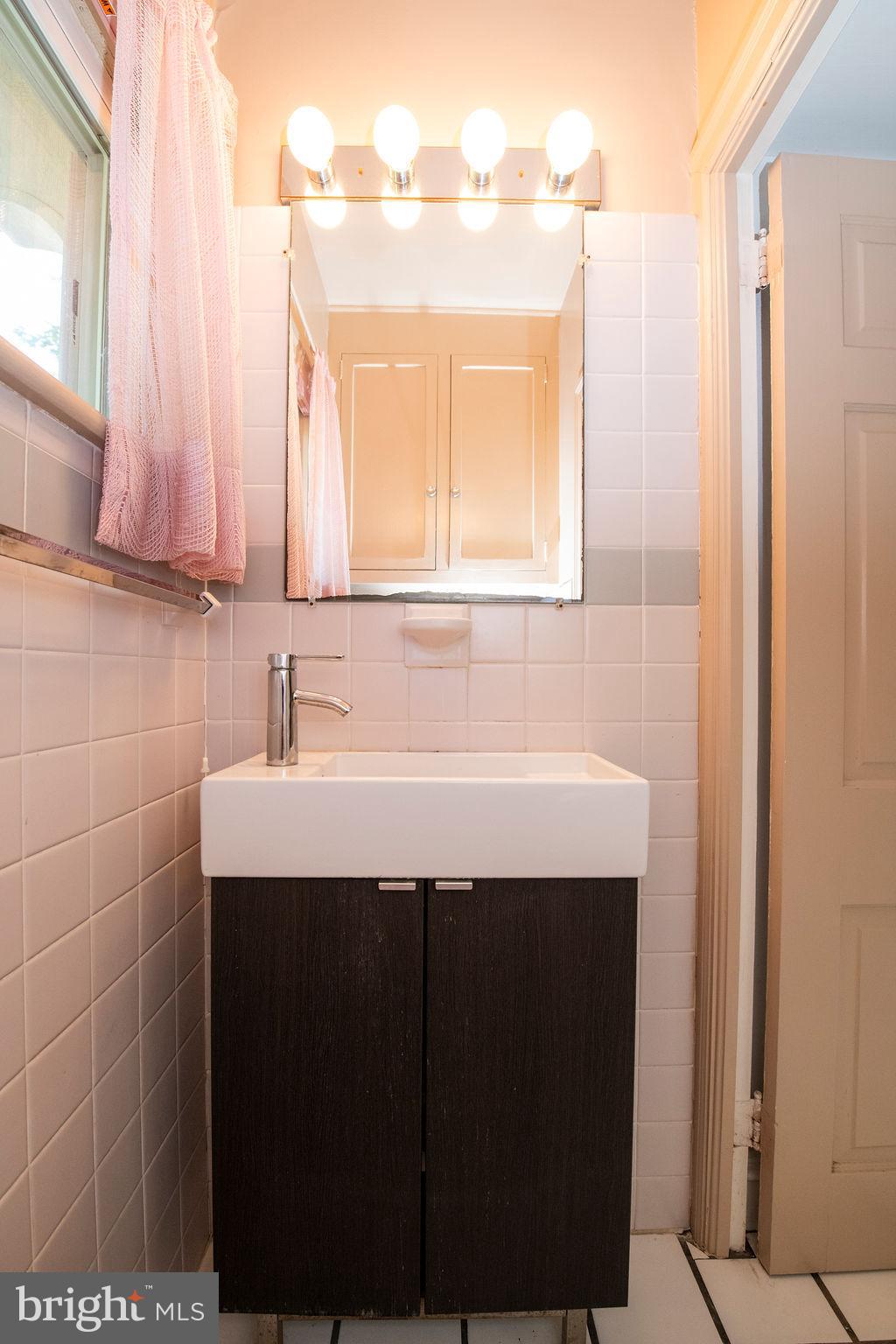 103 Waverly Road Wyncote, PA 19095 - Photo 16 of 41 a bathroom with a sink and a mirror