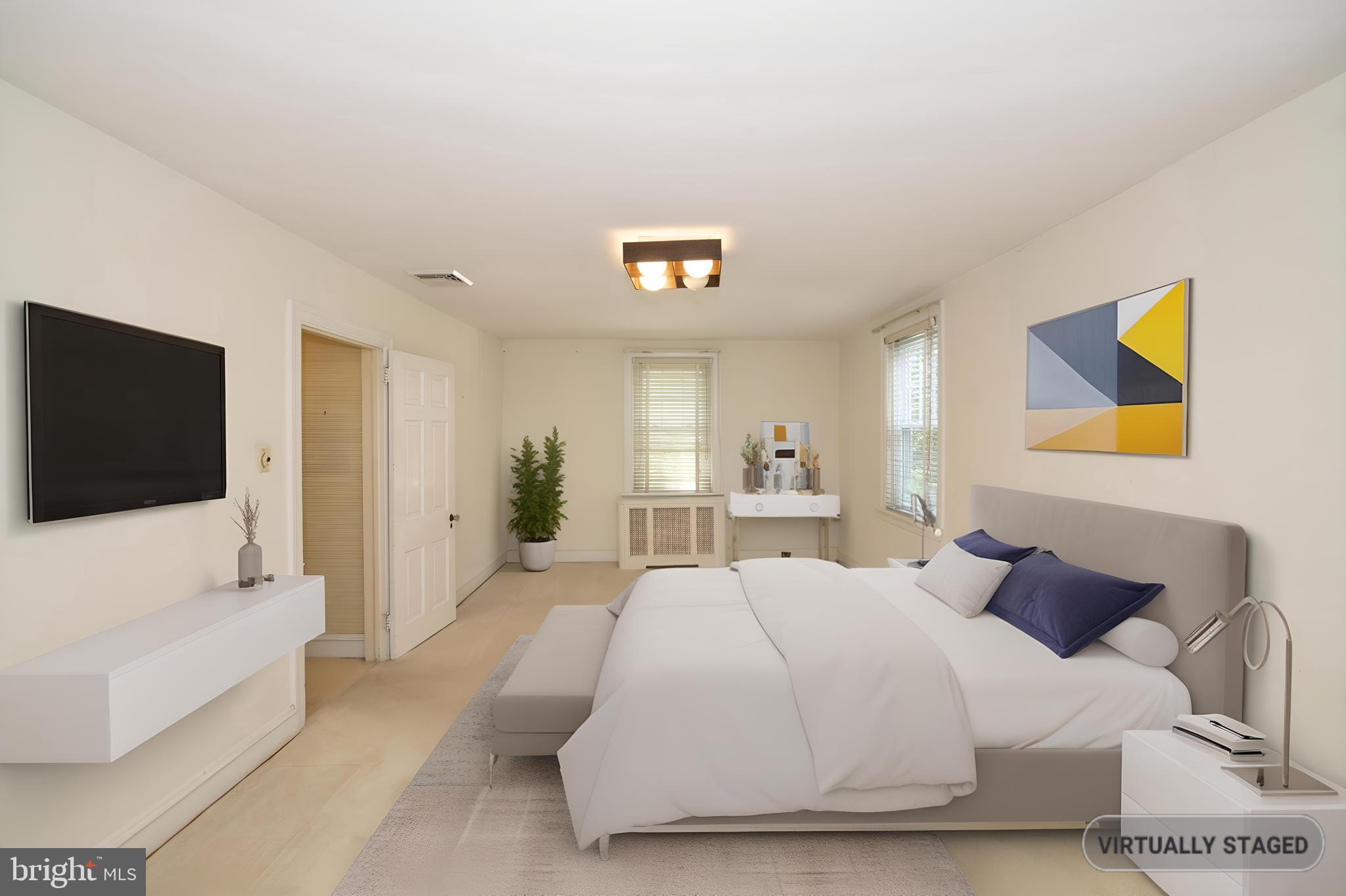 103 Waverly Road Wyncote, PA 19095 - Photo 19 of 41 a spacious bedroom with a bed and a flat screen tv