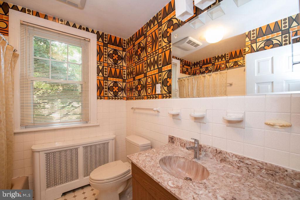 103 Waverly Road Wyncote, PA 19095 - Photo 26 of 41 a bathroom with a sink a toilet and a mirror