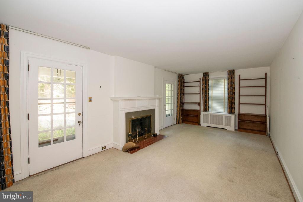 103 Waverly Road Wyncote, PA 19095 - Photo 6 of 41 an empty room with furniture and a fireplace