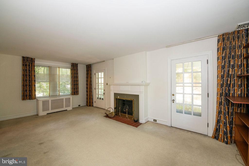 103 Waverly Road Wyncote, PA 19095 - Photo 7 of 41 an empty room with windows and fireplace