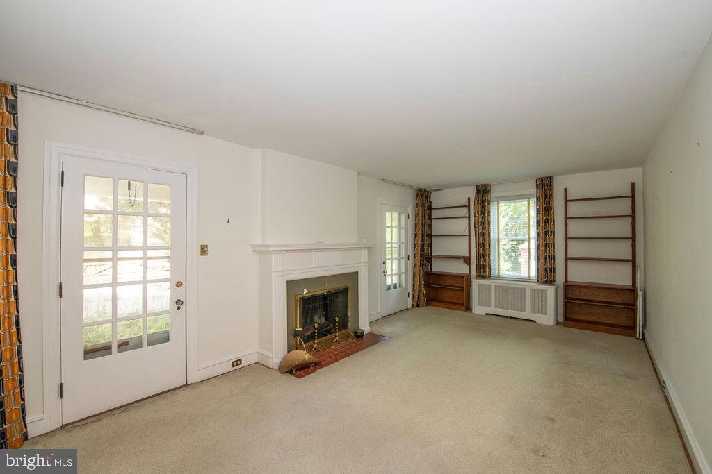 103 Waverly Road Wyncote, PA 19095 - Photo 8 of 41 an empty room with furniture and a fireplace