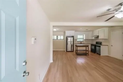 a kitchen with furniture and refrigerator
