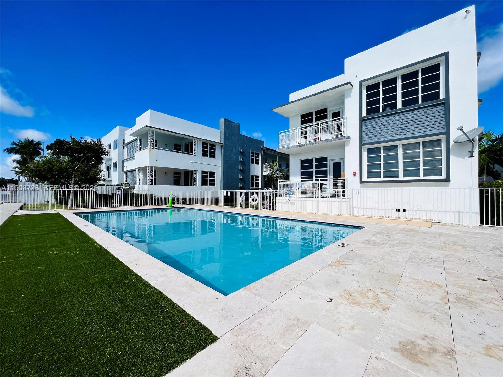 960 Bay Drive, Unit 902 Miami Beach, FL 33141 - Photo 1 of 25 a view of a house with a swimming pool and sitting area