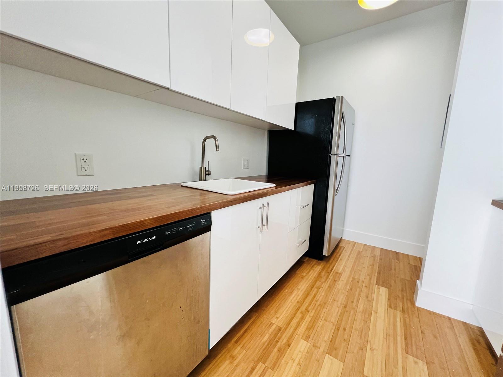 960 Bay Drive, Unit 902 Miami Beach, FL 33141 - Photo 9 of 25 a view of a kitchen with a sink and dishwasher