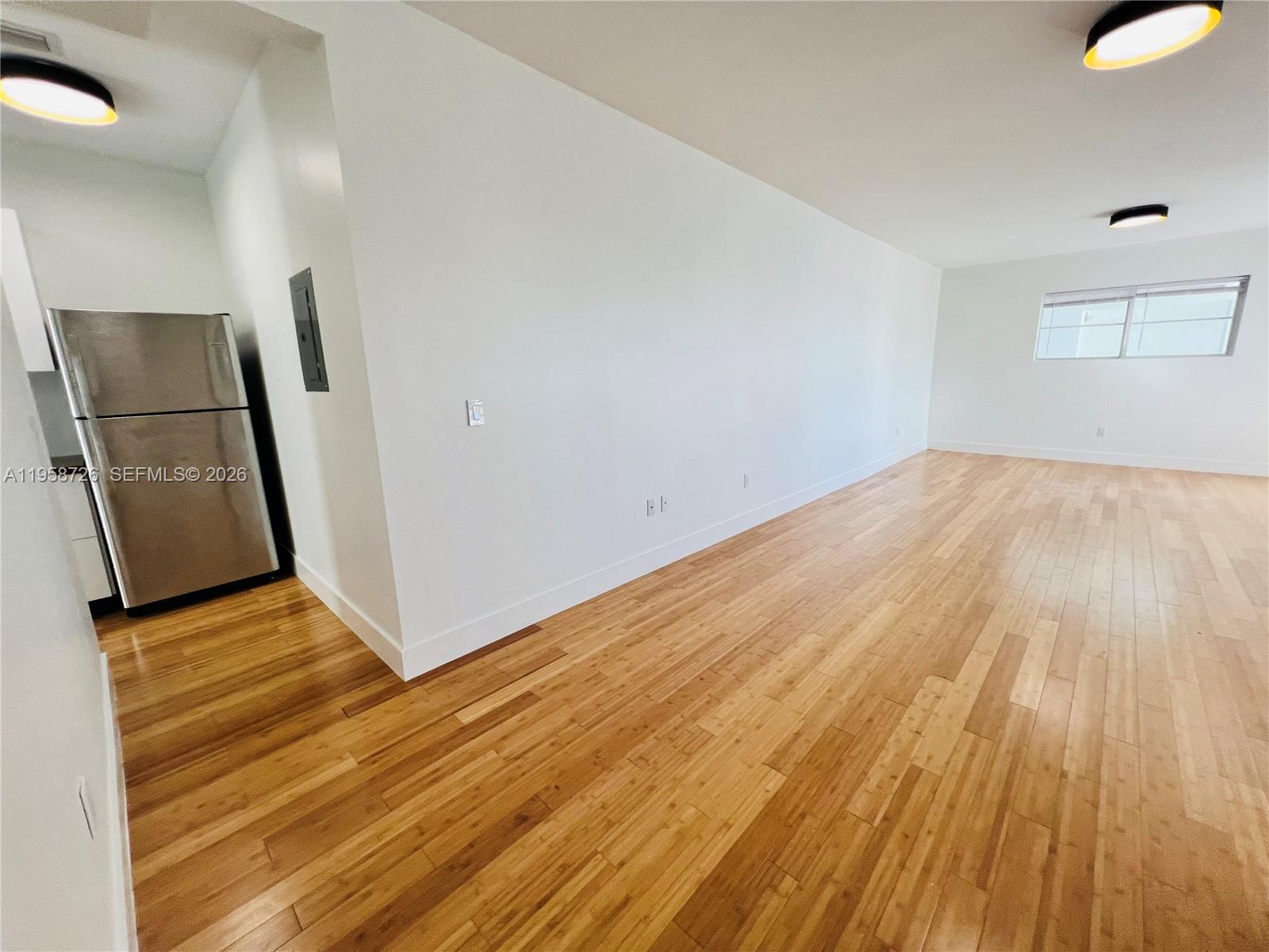 960 Bay Drive, Unit 902 Miami Beach, FL 33141 - Photo 10 of 25 a view of a room with wooden floor and a sink