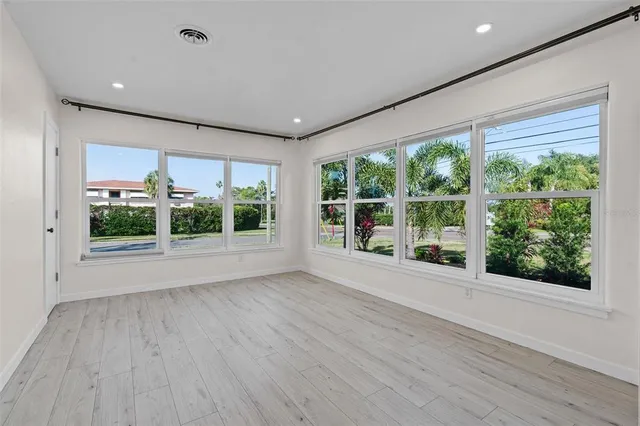 a view of room with window and wooden floor