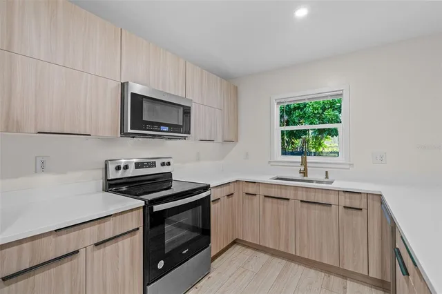 a kitchen with a sink stove and microwave