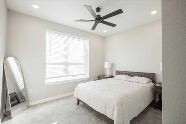 a bedroom with a bed and window
