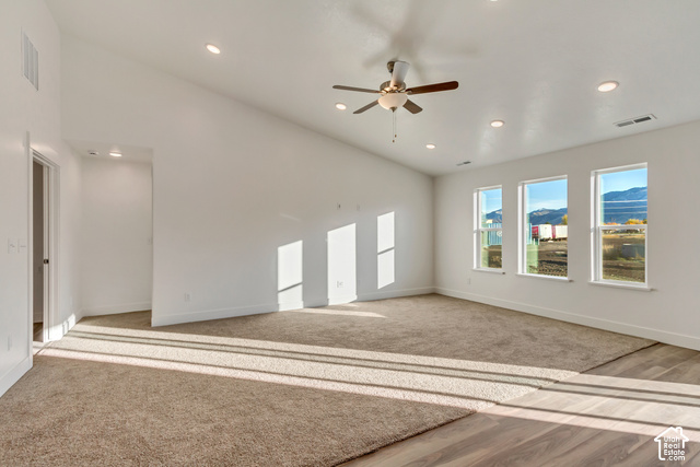 3357 South 960 West Logan, UT 84321 - Photo 4 of 17 Spacious primary suite bathed in natural light through multiple windows, featuring neutral wall finishes, recessed ceiling lighting, and a ceiling fan with brushed metal accents