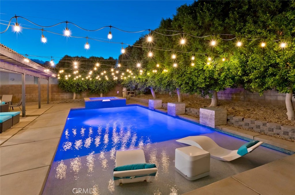 a view of a patio with table and chairs with an umbrella and yard