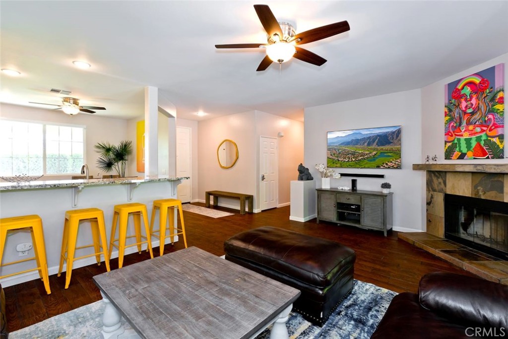80750 Diamondback Trail Indio, CA 92201 - Photo 17 of 67 a living room with furniture a fireplace and a flat screen tv