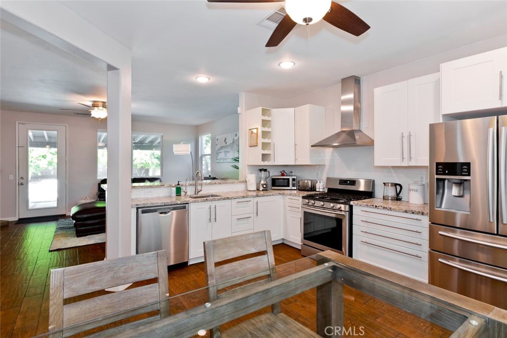 80750 Diamondback Trail Indio, CA 92201 - Photo 19 of 67 a kitchen with kitchen island a stove a sink and a refrigerator