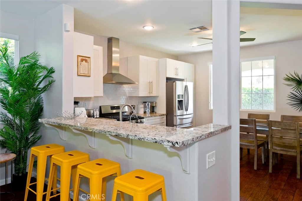 80750 Diamondback Trail Indio, CA 92201 - Photo 21 of 67 a kitchen with stainless steel appliances granite countertop a sink a stove and a wooden floors
