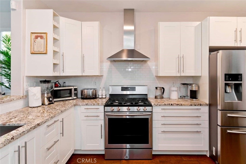 80750 Diamondback Trail Indio, CA 92201 - Photo 22 of 67 a kitchen with granite countertop a stove sink and refrigerator