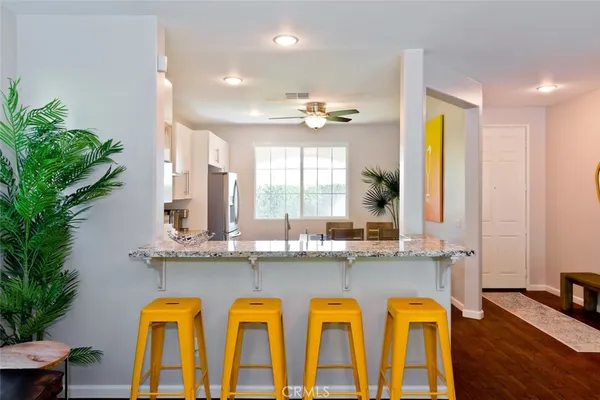 a dining room with furniture a window and wooden floor