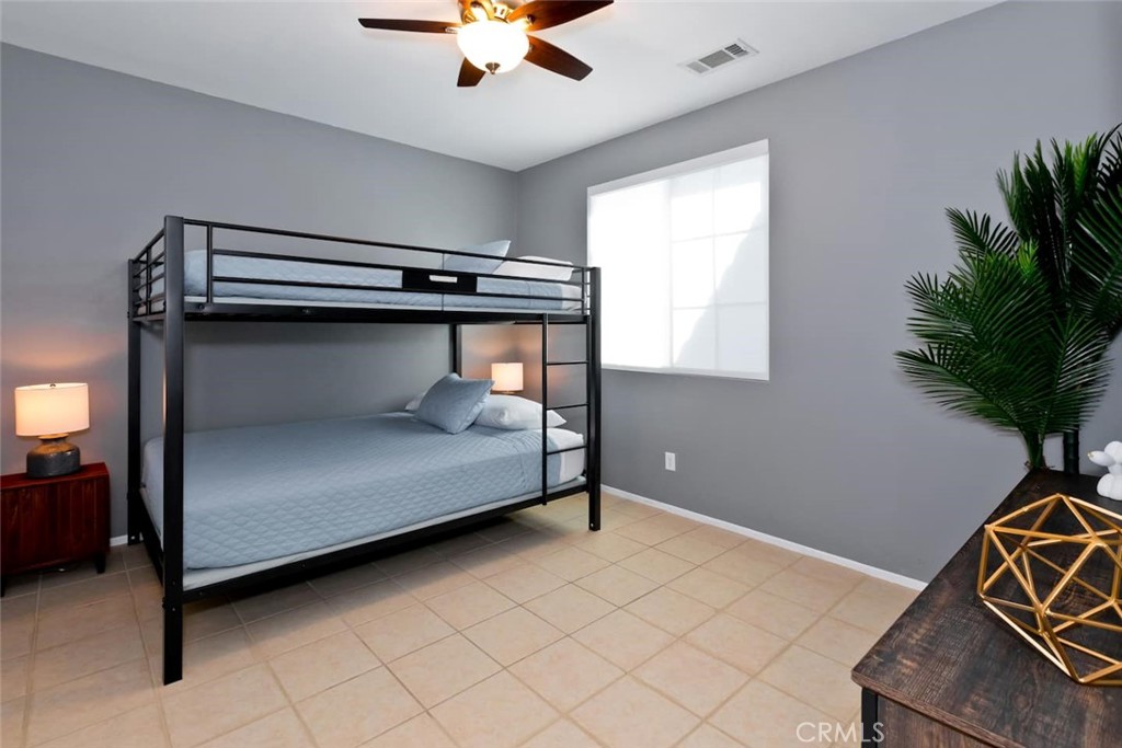 80750 Diamondback Trail Indio, CA 92201 - Photo 36 of 67 a bedroom with a bed and a potted plant