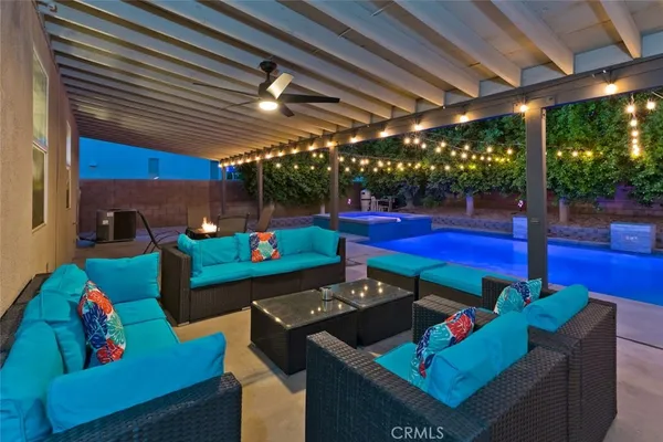 a kitchen with stainless steel appliances dining table a large window and living room view