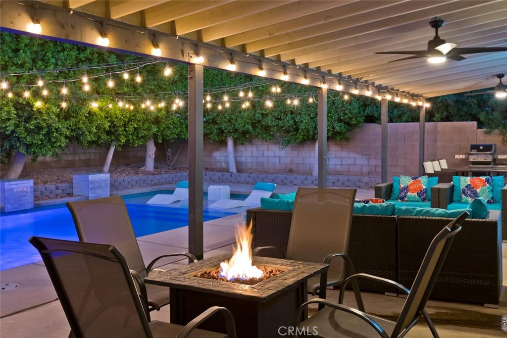 80750 Diamondback Trail Indio, CA 92201 - Photo 63 of 67 a view of a patio with a dining table and chairs with wooden floor