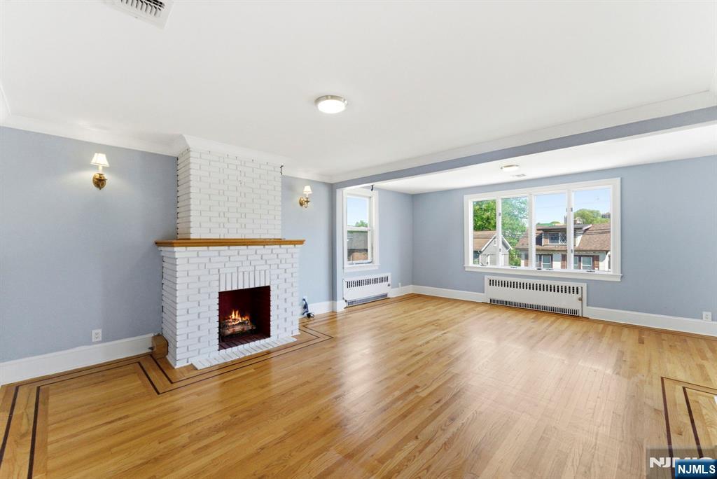773 Kingsland Avenue Ridgefield, NJ 07657 - Photo 5 of 13 an empty room with floor to ceiling window and fireplace