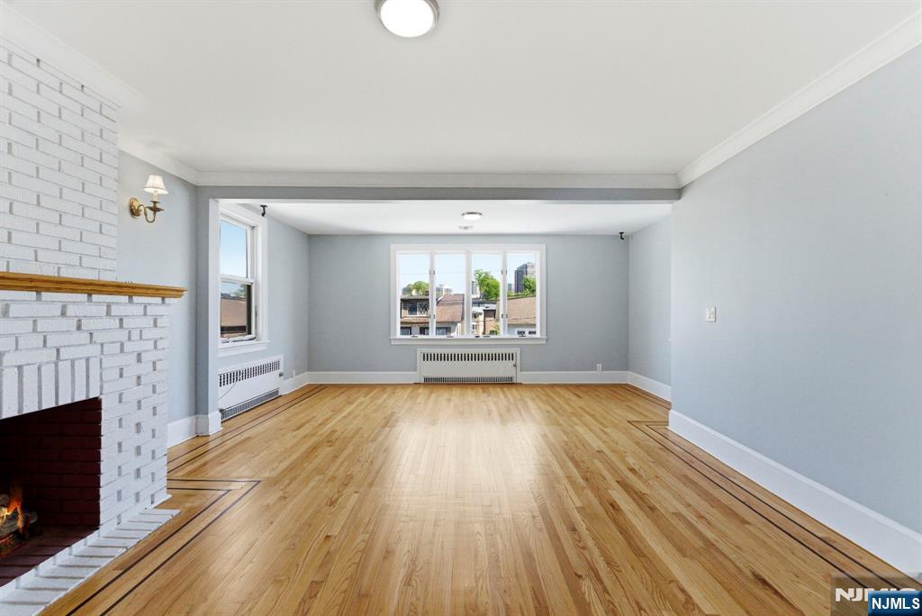 773 Kingsland Avenue Ridgefield, NJ 07657 - Photo 6 of 13 wooden floor in an empty room with a fireplace