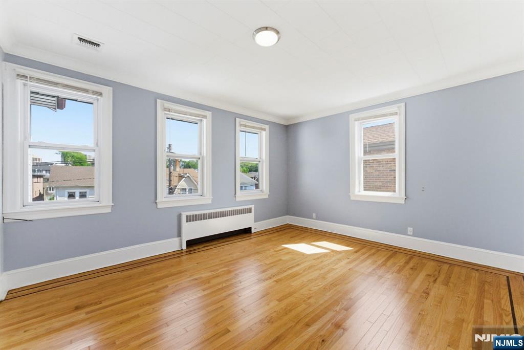 773 Kingsland Avenue Ridgefield, NJ 07657 - Photo 7 of 13 a view of an empty room with wooden floor and a window